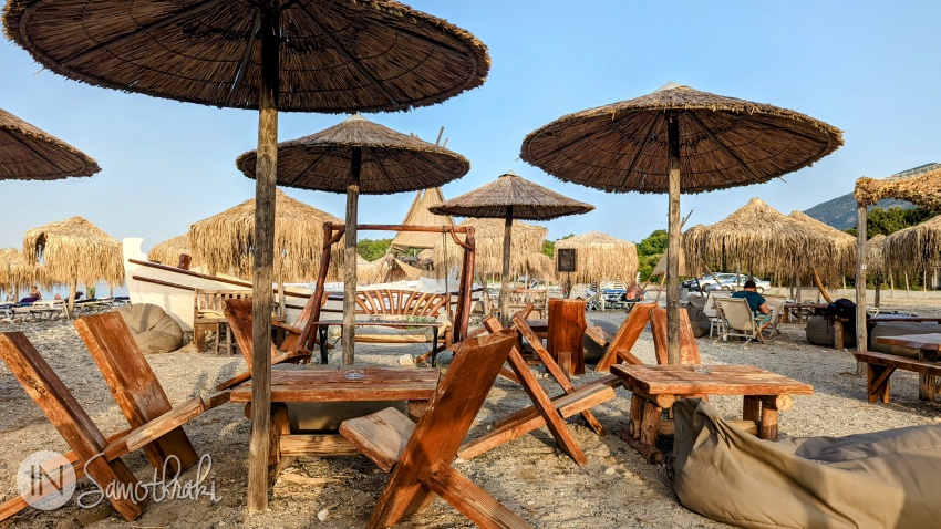 Reed umbrellas and wood furniture on the beach in Therma